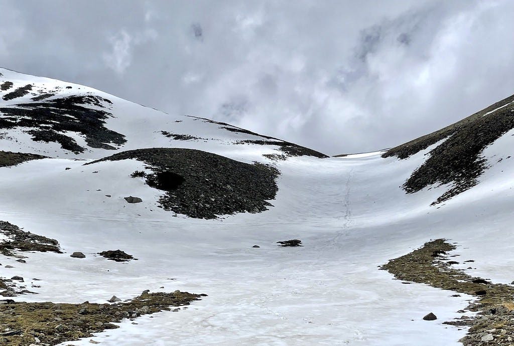 Looking back at the couloir just as storm clouds roll in.